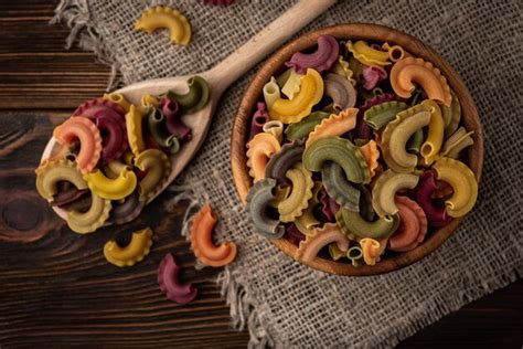 Premium Photo Colorful Pasta On Dark Wooden Background