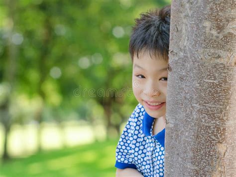 Boy Peeking From Behind Tree Stock Image Image Of Person Happy 52308563