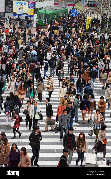 Japanese Street Scene Showing Crowds Of People Crossing The Street On A