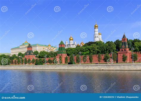 Moscow Kremlin On A Moskva River Background Against Blue Sky In Sunny