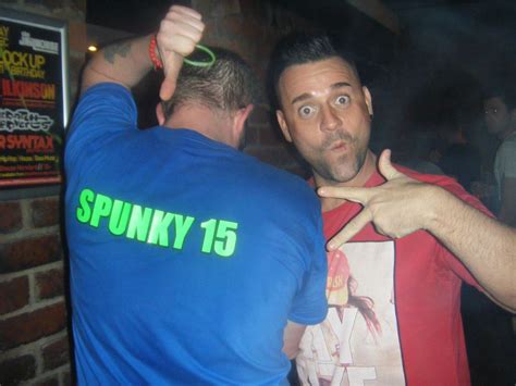 two men standing next to each other in front of a brick wall with the words punky 15 on it