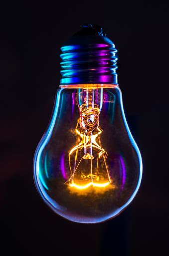 Light Bulb Glowing With Black Background Stock Photo Download Image