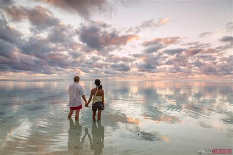 Couple Enjoying Sunset On Tropical Beach Aitutaki Cook Islands