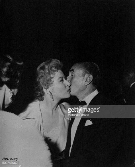 Actress Greer Garson And Producer J L Warner Kissing At The Premiere