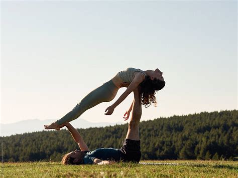 Flexible Relaxed Couple In Acro Yoga Pose On Lawn Stock Image
