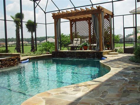 A Freeform Pool With A Pergola Built In Flagstone Decking All The Way
