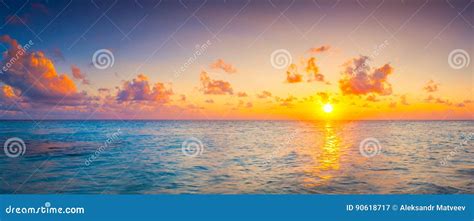 Beautiful Colorful Sunrise At The Sea With Dramatic Clouds And Sun