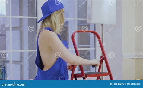 Beautiful Naked Girl In Blue Overalls Posing For Camera Stock Footage