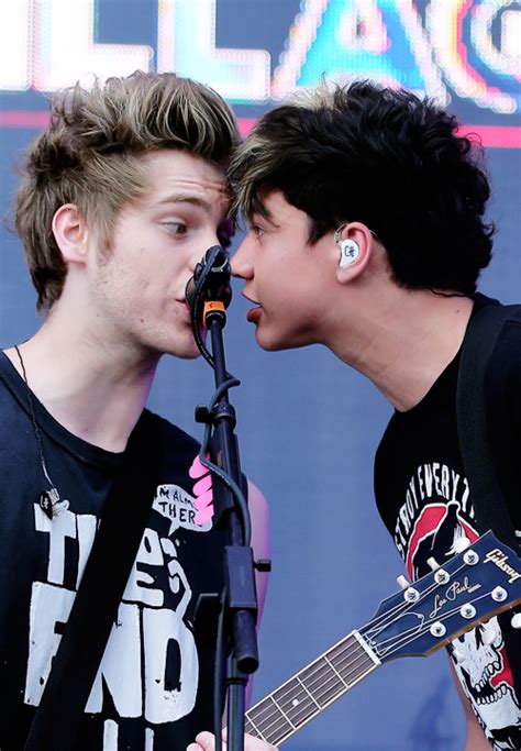 Luke Hemmings And Calum Hood Of 5 Seconds Of Summer Perform Onstage During The 2014 Iheartradio