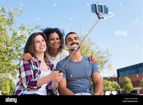 Friends Taking A Photo With A Selfie Stick Stock Photo Alamy