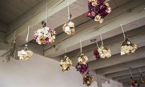 Typically, people dry fresh flowers and herbs by hanging them from the ceiling or on a wall before unhanging them for reuse (e.g., for making potpourri, for cooking with, etc.). Hanging gardenDried-flower bouquets hang from the ceiling ...