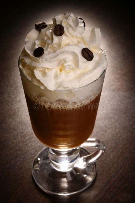 Coffee Drink With Whipped Cream In A Glass On A Dark Table Stock Image