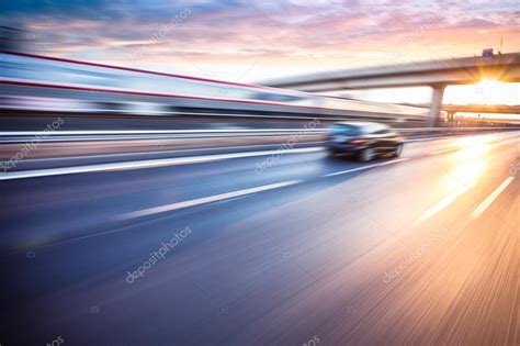 Car Driving On Freeway At Sunset Motion Blur Stock Photo By ©06photo