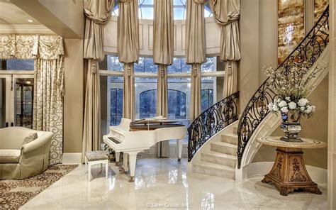 A Grand Piano Sits In The Center Of This Living Room With Marble Floors