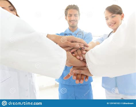 Doctors And Nurses In A Medical Team Stacking Hands Stock