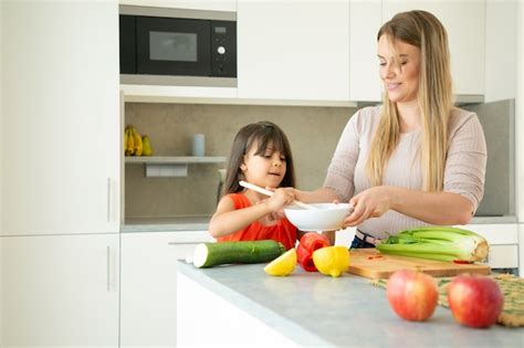 Free Photo Happy Mom And Daughter Cooking Dinner Together Girl And Her Mother Peeling And