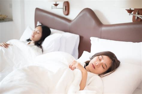 premium photo two asian women sleeping on bed together people and lifestyles theme