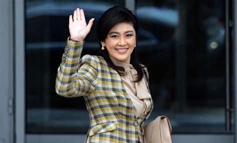 Thai Prime Minister Yingluck Shinawatra Waves As She Arrives To Attend