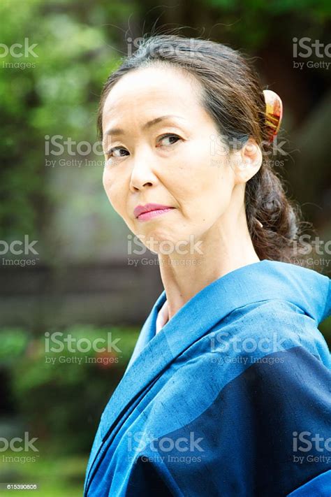 Suspicious Critical Mature Japanese Woman Looking Back Over Her