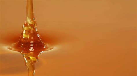 Macro Footage Of Golden Honey Being Poured In A Steady Stream Stock