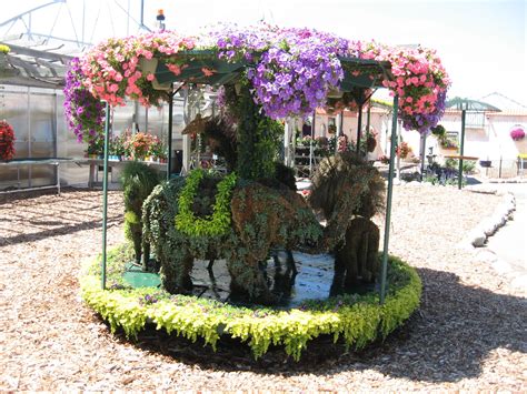 A Carousel Made Out Of Fake Flowers In A Garden