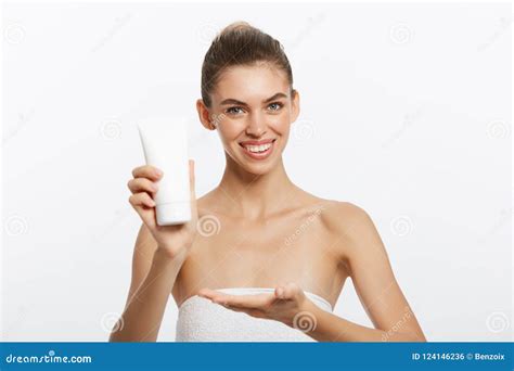 Close Up Beauty Portrait Of A Smiling Beautiful Half Naked Woman Applying Face Cream Isolated