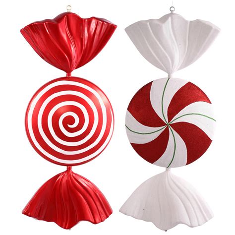 Two Red And White Christmas Ornaments Hanging From Strings One With