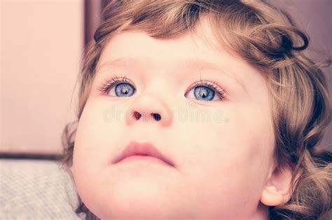 Portrait Of A Young Child With Blue Eyes Close Up Stock Photo Image