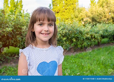 Outdoor Portrait Of A Little Girl Outdoors On A Sunny Day Stock Photo