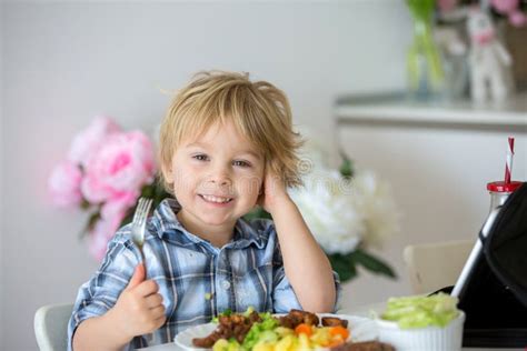 Little Toddler Child Blond Boy Eating Boiled Vegetables Broccoli