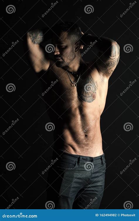 Tattooed Man Show Muscular Torso Sportsman With Six Pack And Ab Bodybuilder With Biceps And