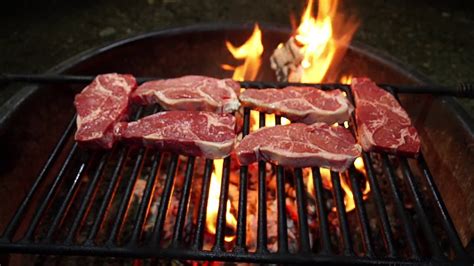 steaks grilling over a wood fire youtube