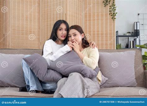Lgbt Two Beautiful Scared Girls Watching Horror Movie At Living Room