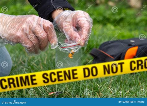 Detective Collecting Evidence In A Crime Scene Forensic Specialists
