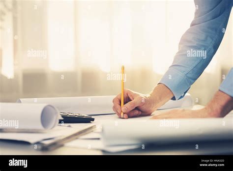 Architect Working With Blueprints In Office Stock Photo Alamy