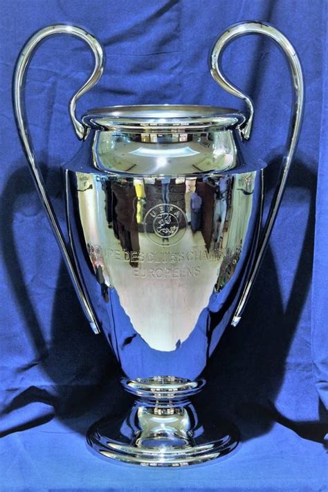 A narrow base shaped into a rounded body of the trophy. Replica UEFA Champions League Trophy