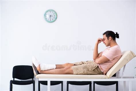 Young Injured Man Waiting For His Turn In Hospital Hall Stock Image