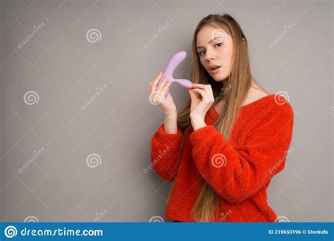 A In The Hands Of An Attractive Woman In A Red Sweater Who Makes A