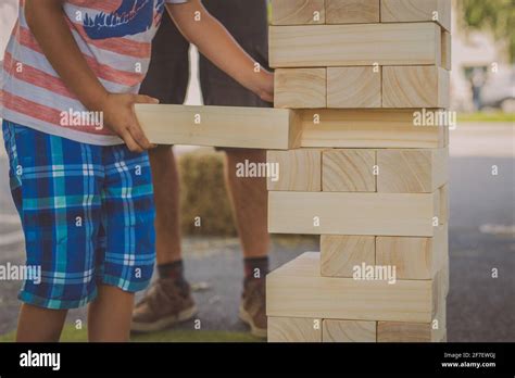 Kid Playing Maxi Jenga Game A Game Where Big Wooden Blocks Are Removed