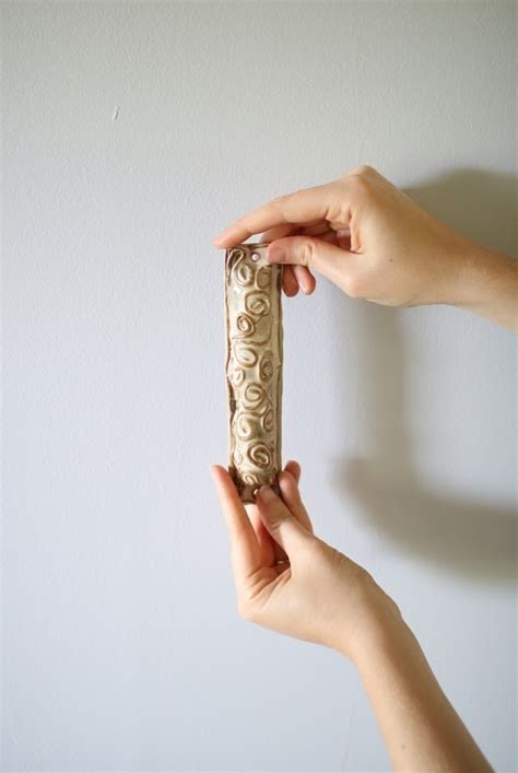 A mezuzah is affixed upon all the doorways of jewish homes and businesses, except for bathrooms. land of honey: How To Hang a Mezuzah
