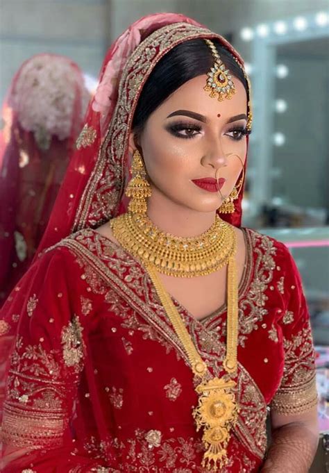 red and gold bridal outfit with stunning jewelry