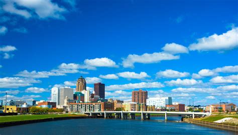 Des Moines Skyline With Puffy Clouds And River