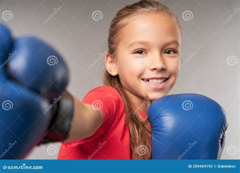 Cheerful Girl Boxer Practicing Boxing Punches In Studio Stock Photo