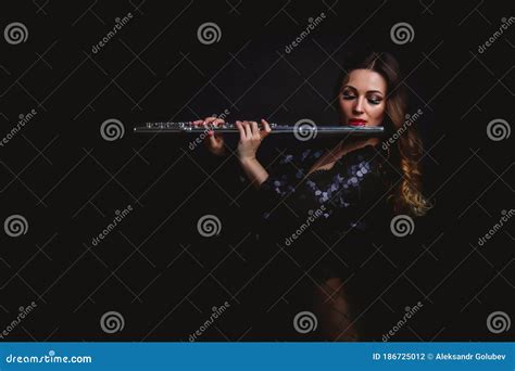 Female Girl Artist In Suit With Flute On Black Background Flute In