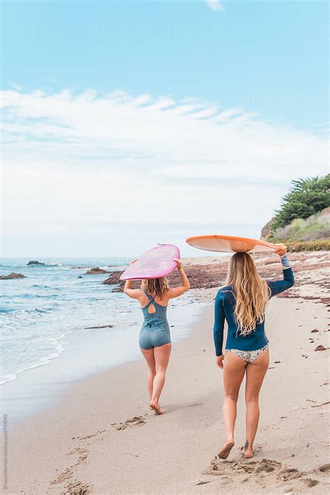Two Women Surfers On Beach By Stocksy Contributor Briana Morrison Stocksy