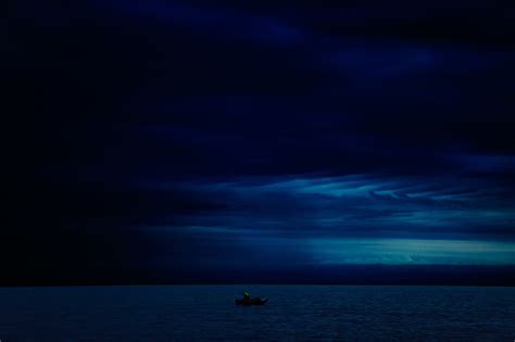 1080x2316 Resolution Dark Evening Blue Cloudy Alone Boat In Ocean