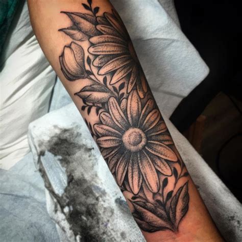 Black And Grey Daisy Flower Tattoo On Forearm