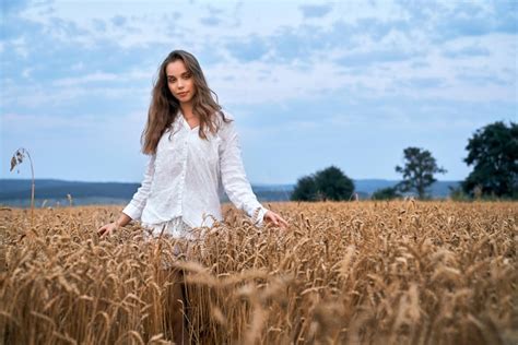 Premium Photo Young Woman Posing On Yellow Wheat Field
