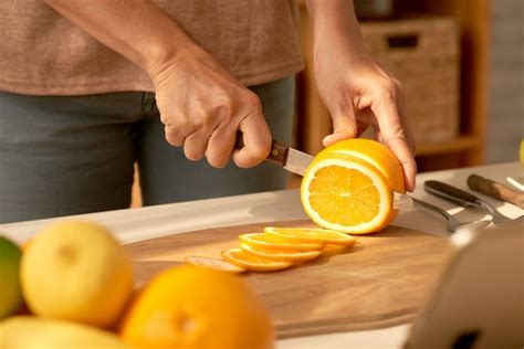 Free Photo Cutting Orange In Slices