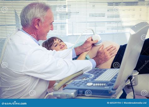 Male Doctor Doing Ultrasound Test On Pregnant Woman Stock Photo Image